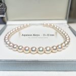 An 11 to 12 mm Aurora Hanadama Akoya strand in its box