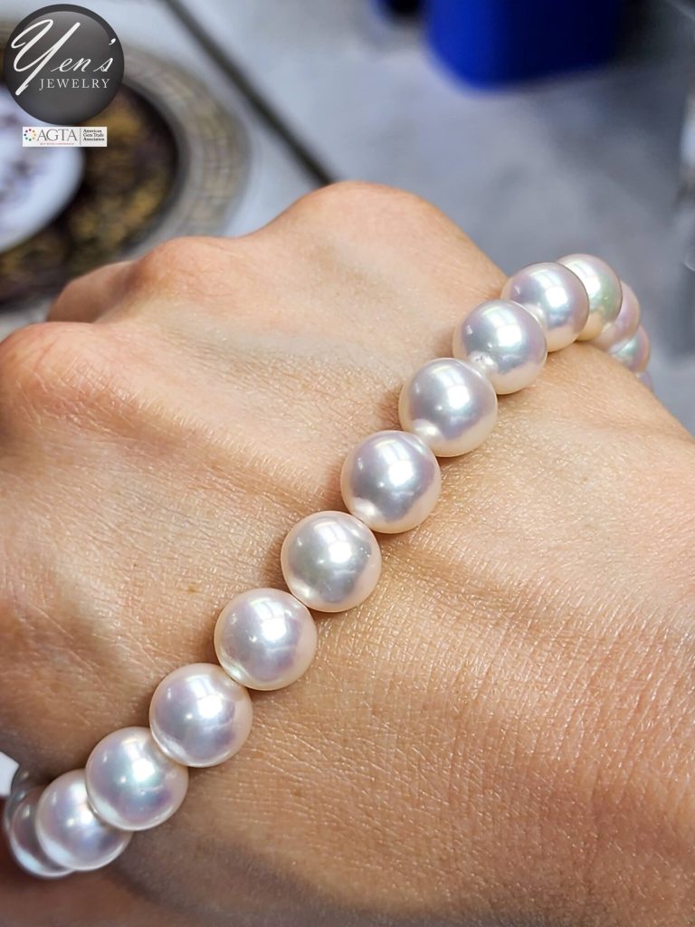 11 to 12 mm Hanadama Akoya pearls wrapped around a wrist to show scale