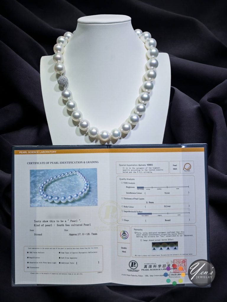 The Aurora Venus South Sea strand on a display bust above its PSL report, with the report number blurred