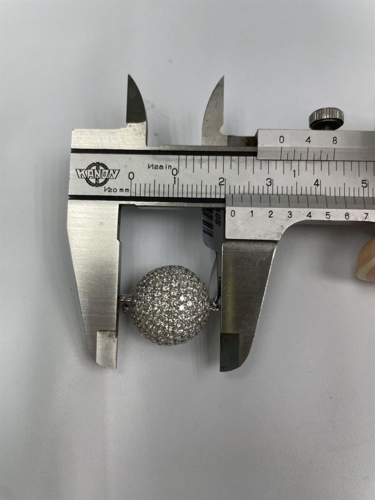 The pave diamond ball clasp measured with a caliper