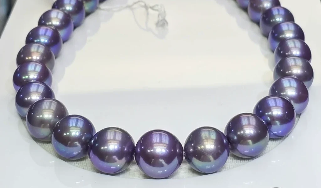 Strand of round purple Edison freshwater pearls with blue and pink overtones