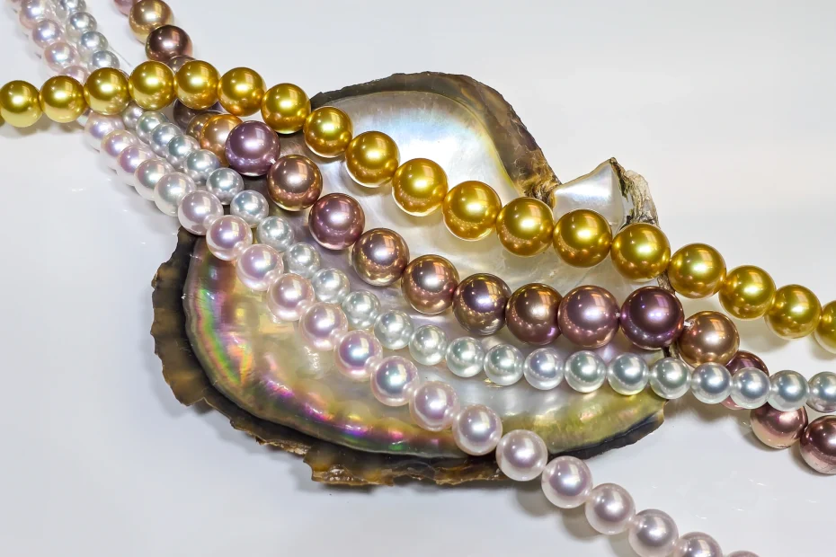 Strands of golden South Sea, Edison and white pearls draped over an oyster shell